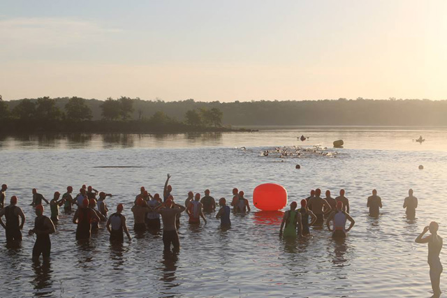 Open water swimmers starting at the Tulsa Triathlon